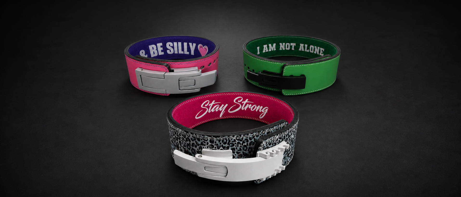 Wide banner showing three colourful custom lever powerlifting belt design ideas