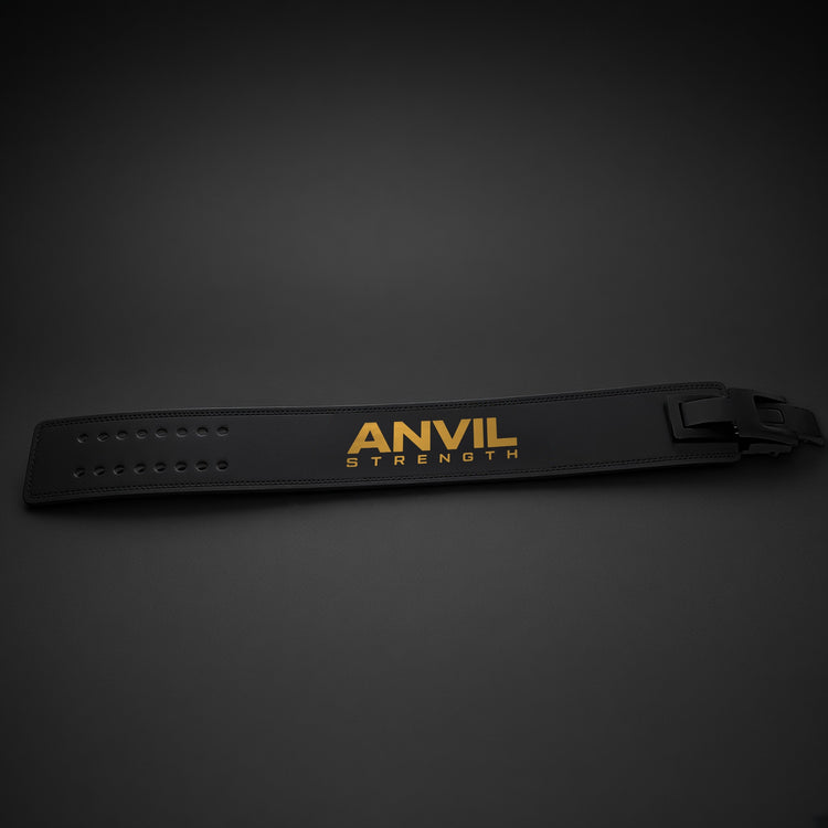 Anvil Lever Belt, black leather outside with gold ANVIL STRENGTH logo, laid flat