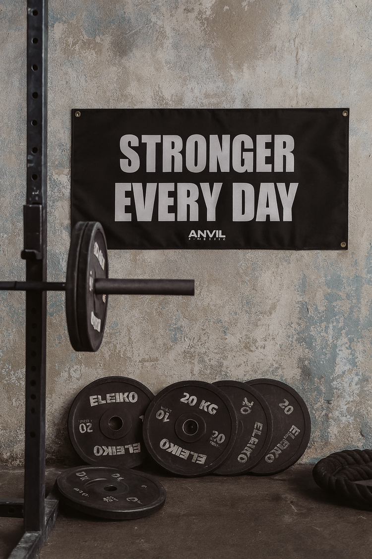 Gym setting with weightlifting equipment and 'Stronger Every Day' banner.