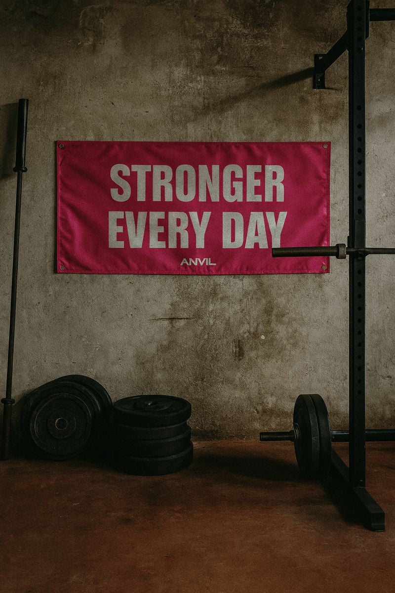 Pink banner with 'Stronger Every Day' text in a gym setting. Motivational gym flag banner.