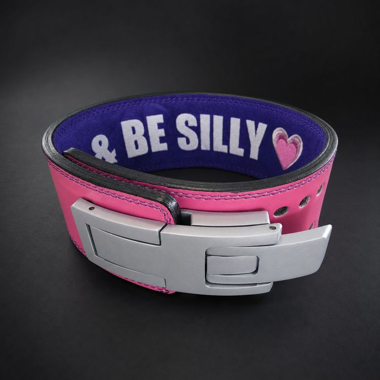 Pink and purple custom lever powerlifting belt with silver lever and "BE SILLY" text