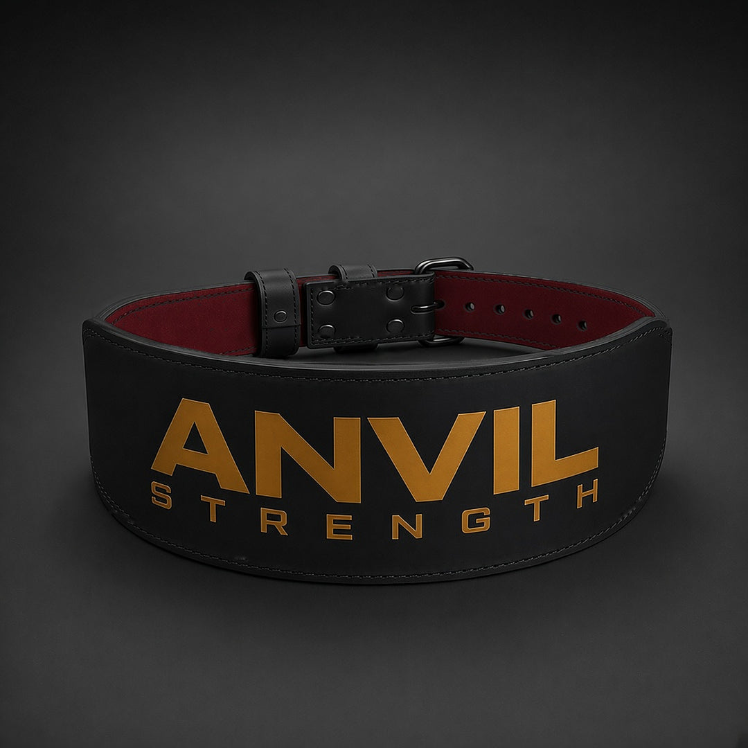 Anvil Strength training belt front, black leather with gold ANVIL STRENGTH logo and black single-prong buckle